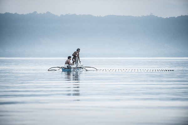Husband and wife fishing at dawn.  El Nido, Palawan, Philippines. April 2014.